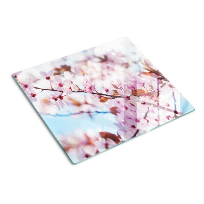 Skærebræt i glas Kirsebærblomster på en blå baggrund