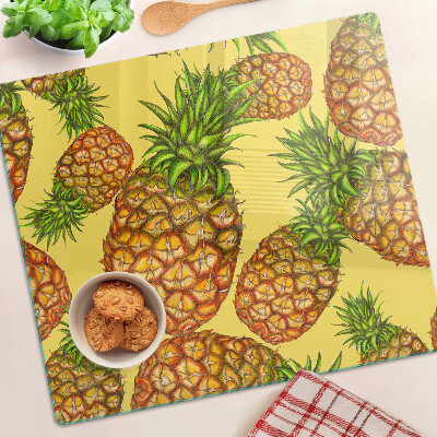 Skærebræt i glas Ananas på en gul baggrund