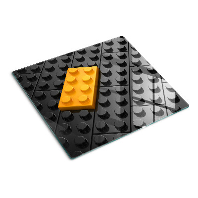 Glas skærebræt LEGO-klodser på en sort baggrund