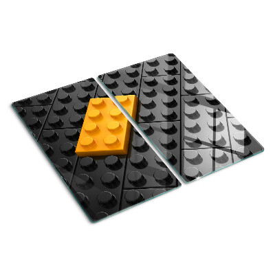 Glas skærebræt LEGO-klodser på en sort baggrund