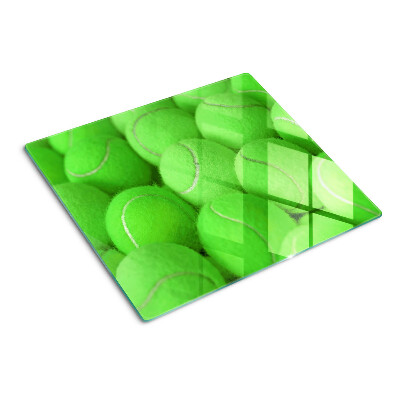 Glas skærebræt Tennisbolde på en grøn baggrund