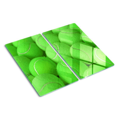 Glas skærebræt Tennisbolde på en grøn baggrund