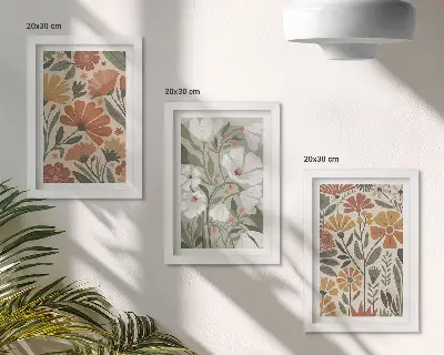 Billeder og rammer med blomstermønstre i orange og grønne nuancer