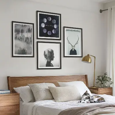 Billedvæg over sofa med motiv af skov, tåge, måne, kranium og kvinde