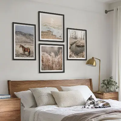 Billedvæg over sofa med motiv af heste i et landskab med søgræs og skov