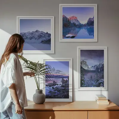 Billedvæg over sofa med bjerglandskaber, solnedgang og vand