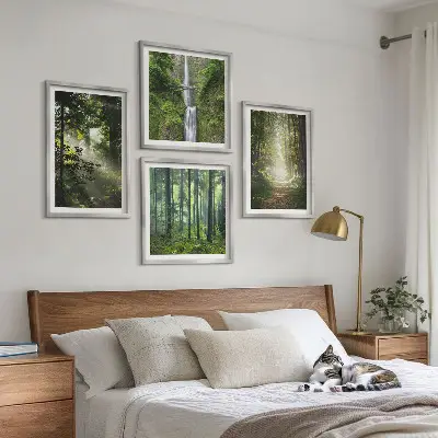 Billedvæg over sofa med motiv af grønne skove med lysstråler