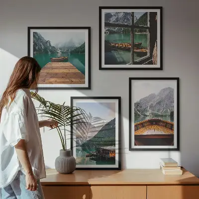 Billedvæg over sofa med bjerglandskaber og hyttebåde