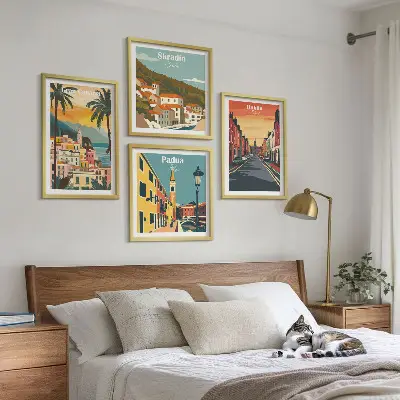 Billedvæg over sofa med motiver af bylandskaber og natur