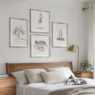 Billedvæg over sofa med motiv af hus på vandet og sejlbåd
