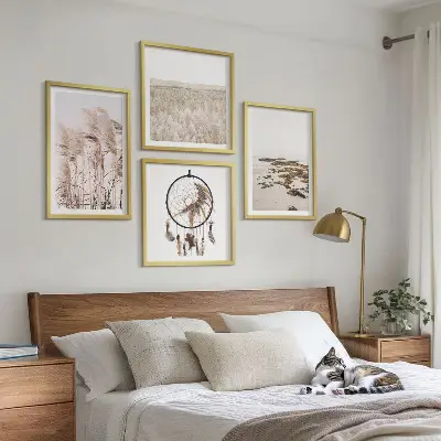 Billedvæg over sofa med motiv af græsmarker og strand i boho-stil