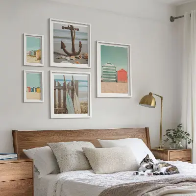 Billedsæt over sofa med motiv af stilfulde strandhuse ved havet